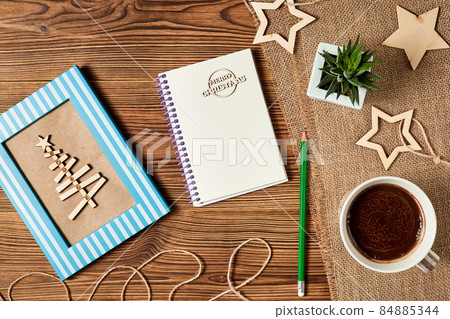 Christmas composition of open blank notepad, coffee cup, Christmas tree and Cactus on wooden background 84885344