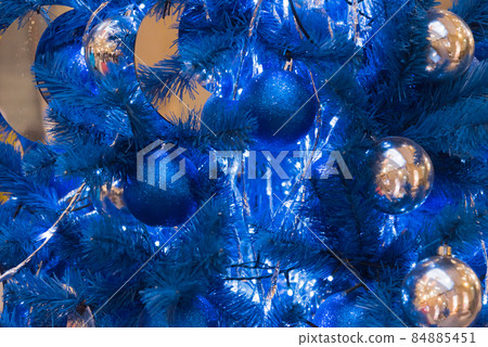 Blue Christmas tree with blue decorations. Monochrome decoration of Christmas and New Year. Stylish and magical, unusual Christmas tree. 84885451