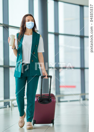 Young tourist woman with baggage in international airport Young tourist woman with baggage in international airport 84885837