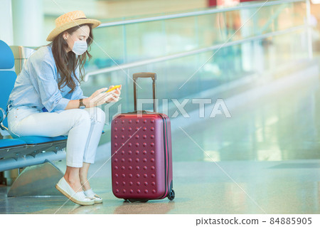 Young tourist woman with baggage in international airport Young tourist woman with baggage in international airport 84885905