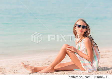 Adorable little girl have fun at tropical beach during vacation Adorable little girl have fun at tropical beach during vacation 84886219