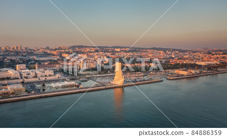 Wonderful sunset landscape overlooking the Portuguese Monument to Discoveries, Padrao dos Descobrimentos. Belem. Jeronimos Castle in background. Wonderful sunset landscape overlooking the Portuguese Monument to Discoveries, Padrao dos Descobrimentos. Belem. Jeronimos Castle in background. 84886359