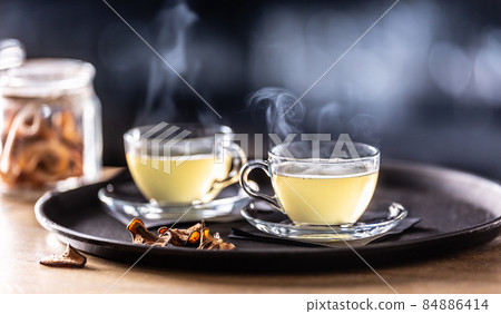 Two glasses of mulled wine and dried fruit on the bar counter. Whiskey drinks Hot Teddy in tea glasses 84886414