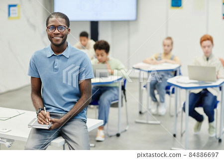 Smiling Teacher in School Classroom Smiling Teacher in School Classroom 84886697