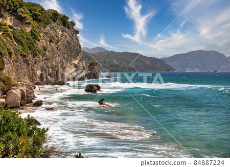 Sea waves crashing onto rocks with water splashes. Corfu island, Greece. Sea waves crashing onto rocks with water splashes. Corfu island, Greece. 84887224