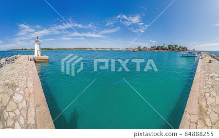 Panoramic view over the harbor of the Croatian coastal town of Novigrad in Istria during the day when the weather is clear 84888255