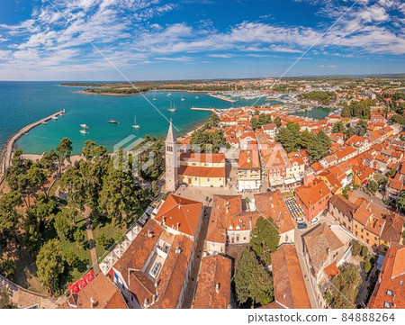 Drone panorama over the roofs of the Croatian coastal town of Novigrad with harbor and church during daytime Drone panorama over the roofs of the Croatian coastal town of Novigrad with harbor and church during daytime 84888264