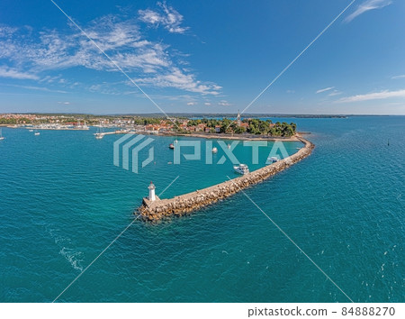 Drone panorama over the Croatian coastal town Novigrad with harbor and promenade taken from the sea side during the day Drone panorama over the Croatian coastal town Novigrad with harbor and promenade taken from the sea side during the day 84888270