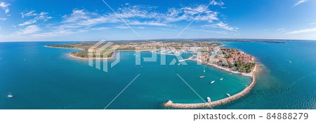 Drone panorama over the Croatian coastal town Novigrad with harbor and promenade taken from the sea side during the day Drone panorama over the Croatian coastal town Novigrad with harbor and promenade taken from the sea side during the day 84888279