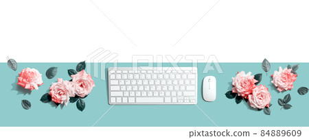 Computer keyboard and a mouse with pink roses Computer keyboard and a mouse with pink roses 84889609
