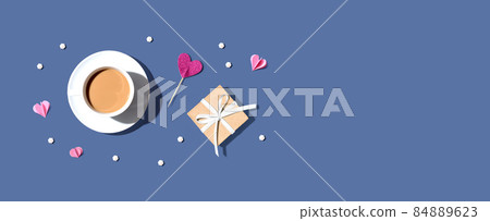 A cup of coffee with a gift box and hearts 84889623
