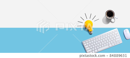 Computer keyboard with a yellow light bulb Computer keyboard with a yellow light bulb 84889631