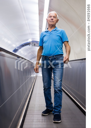 Old man going down to metro station Old man going down to metro station 84891666