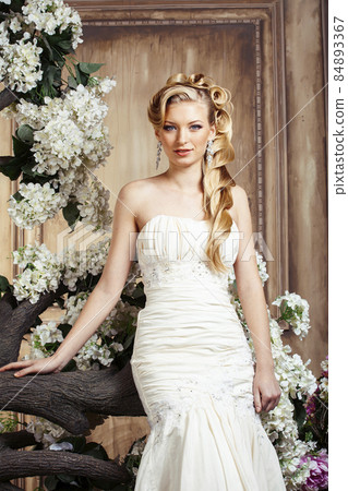 beauty young bride alone in luxury vintage interior with a lot of flowers, makeup and creative hairstyle beauty young bride alone in luxury vintage interior with a lot of flowers, makeup and creative hairstyle 84893367