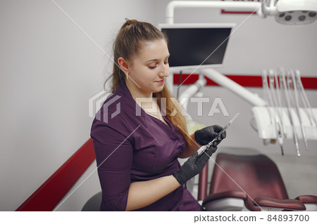 Beautiful dentist working on a dental clinic Beautiful dentist working on a dental clinic 84893700
