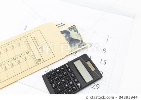 Monthly bag and calculator white background Monthly bag and calculator white background 84893944