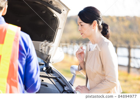 A middle-aged woman who broke down and called for road service 84894977