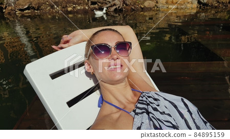 Woman shooting self portrait. Take photo and video on smartphone. Girl rest, relax, walk in sunglasses, make selfie. Blogger broadcast video vlogging. Woman shooting self portrait. Take photo and video on smartphone. Girl rest, relax, walk in sunglasses, make selfie. Blogger broadcast video vlogging. 84895159