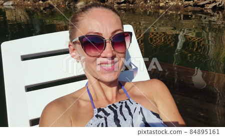 Woman shooting self portrait. Take photo and video on smartphone. Girl rest, relax, walk in sunglasses, make selfie. Blogger broadcast video vlogging. 84895161
