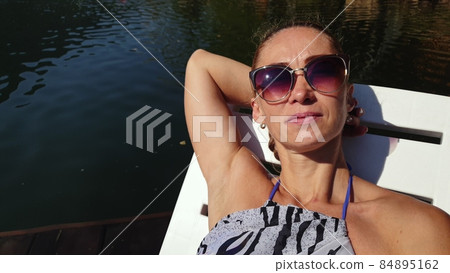 Woman shooting self portrait. Take photo and video on smartphone. Girl rest, relax, walk in sunglasses, make selfie. Blogger broadcast video vlogging. Woman shooting self portrait. Take photo and video on smartphone. Girl rest, relax, walk in sunglasses, make selfie. Blogger broadcast video vlogging. 84895162