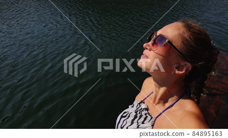 Woman shooting self portrait. Take photo and video on smartphone. Girl rest, relax, walk in sunglasses, make selfie. Blogger broadcast video vlogging. Woman shooting self portrait. Take photo and video on smartphone. Girl rest, relax, walk in sunglasses, make selfie. Blogger broadcast video vlogging. 84895163