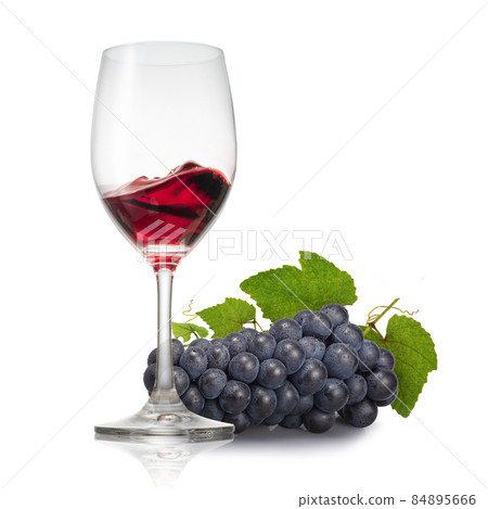 Red wine and grapes poured into a glass Red wine and grapes poured into a glass 84895666