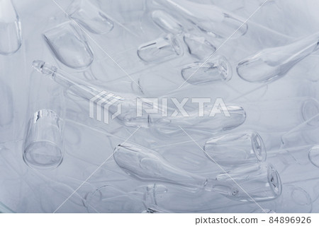 Glass medical ampoule vial for injection. Medicine is liquid sodium chloride with of aqueous solution in ampulla. Close up. Bottles ampule multicolor. Glass medical ampoule vial for injection. Medicine is liquid sodium chloride with of aqueous solution in ampulla. Close up. Bottles ampule multicolor. 84896926