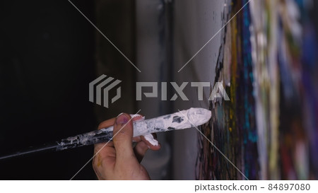 Artist designer draws an eagle on the wall. Craftsman decorator paints a picture with acrylic oil color brush. Close-up dark magic cinematic look. Artist designer draws an eagle on the wall. Craftsman decorator paints a picture with acrylic oil color brush. Close-up dark magic cinematic look. 84897080