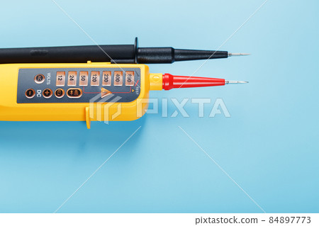 Yellow tester for step-by-step indication of voltage in an electrical circuit on a blue background Yellow tester for step-by-step indication of voltage in an electrical circuit on a blue background 84897773