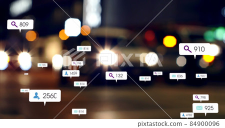 Image of social media icons and numbers over out of focus city and traffic lights Image of social media icons and numbers over out of focus city and traffic lights 84900096