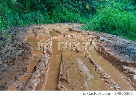 road wet muddy of backcountry countryside in rainy day 84900305