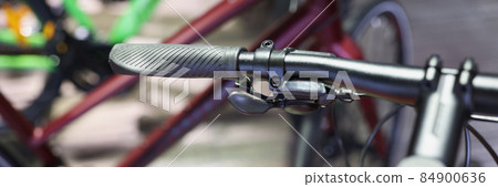 Closeup of hand brake on handlebar of bicycle in workshop Closeup of hand brake on handlebar of bicycle in workshop 84900636