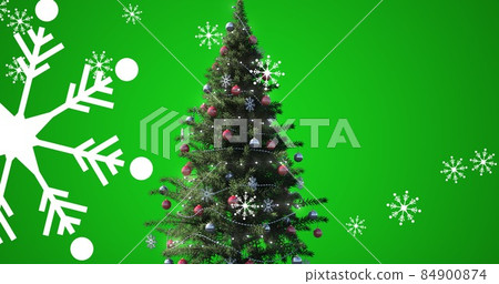 Digital composite of snowflakes and christmas tree over green background with copy space Digital composite of snowflakes and christmas tree over green background with copy space 84900874