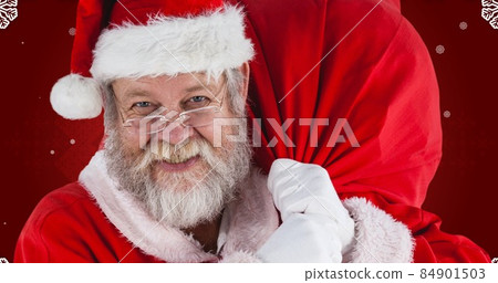 Portrait of happy santa claus carrying bag against maroon background 84901503