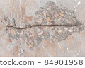 Textured grunge background. An old wall with a peeling cover and a deep pattern. Beige pink background 84901958