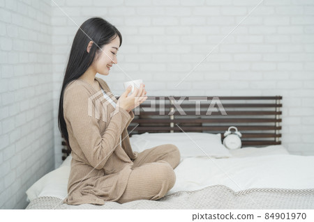 Female drinking hot drink (bedroom) 84901970