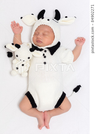 happy newborn baby wearing cute cow costume lying sleep on white background comfortable and safety.Cute Asian infant sleeping and napping on baby bed happy newborn baby wearing cute cow costume lying sleep on white background comfortable and safety.Cute Asian infant sleeping and napping on baby bed 84902271