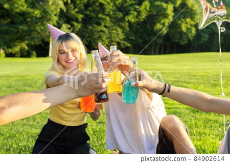 Teenage birthday party picnic on the grass in the park Teenage birthday party picnic on the grass in the park 84902614