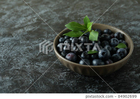 Fresh berry concept with blueberry on black smokey table Fresh berry concept with blueberry on black smokey table 84902699