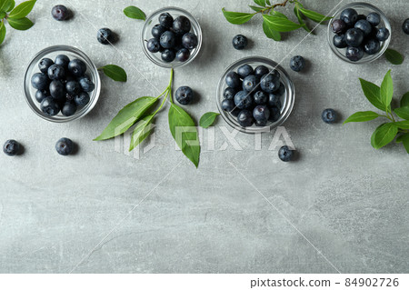 Fresh berry concept with blueberry on gray textured table Fresh berry concept with blueberry on gray textured table 84902726