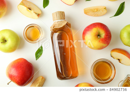 Homemade apple vinegar and ingredients on white background 84902736