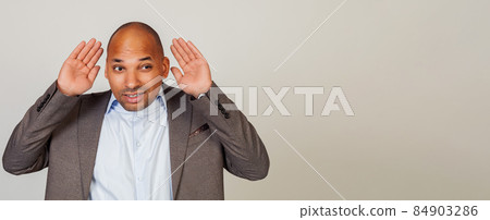 Man African American businessman, holding his hand behind his ear, showing that he does not hear 84903286