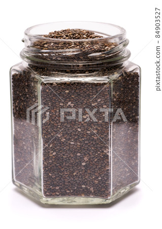 glass can full of organic natural chia seeds close-up isolated on white background 84903527