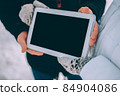 couple demonstration tablet with empty screen. advertising winter theme 84904086