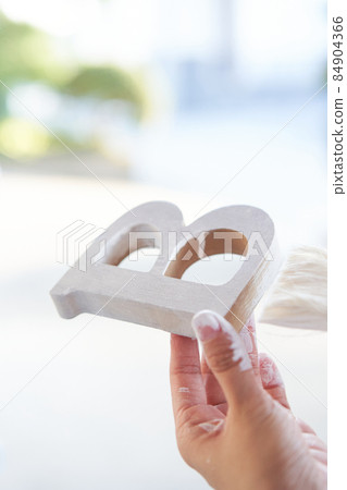 DIY to paint the alphabet with white paint at the hands of a woman DIY to paint the alphabet with white paint at the hands of a woman 84904366