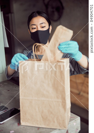 Young waitress working with takeout meal while coronavirus shutdown Young waitress working with takeout meal while coronavirus shutdown 84904701