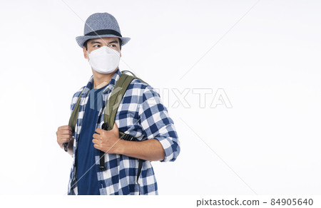Traveler adventure handsome young man wear casual shirt, hat and protective mask safety backpack Traveler adventure handsome young man wear casual shirt, hat and protective mask safety backpack 84905640