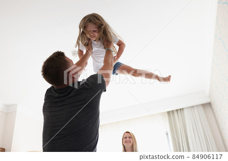 Father throws child in air and play with kid after work Father throws child in air and play with kid after work 84906117