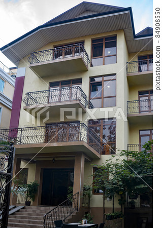 Facade of a hotel building in a summer resort town. Facade of a hotel building in a summer resort town. 84908550