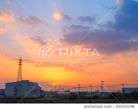 At dusk, a sky with a gradation of orange and blue At dusk, a sky with a gradation of orange and blue 84910396